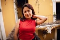 A woman in a red top posing for a photo